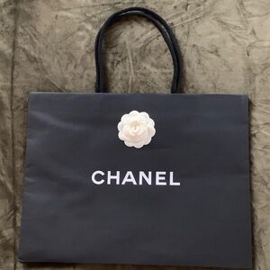 Authentic CHANEL Black Paper Bag with White Camelia